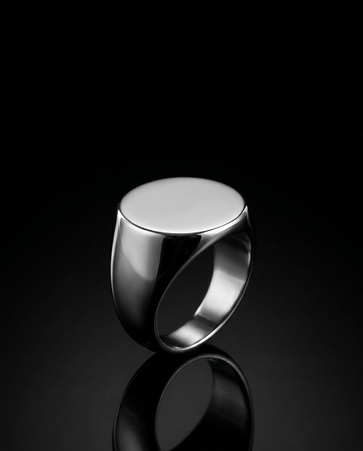 Steel signet ring on black glass